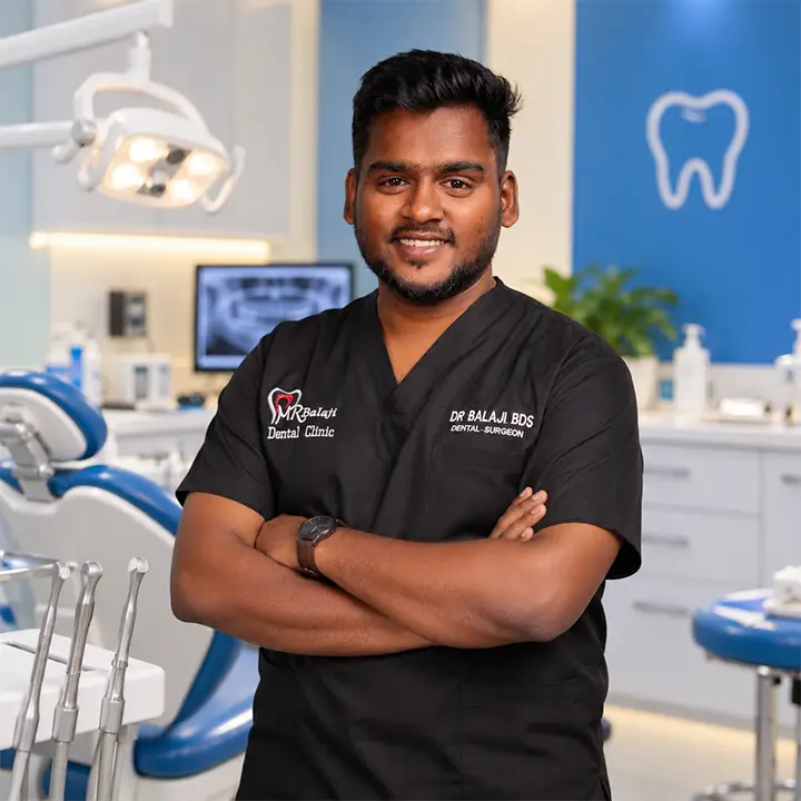 Dr. Balaji BDS dental surgeon standing confidently inside a modern dental clinic