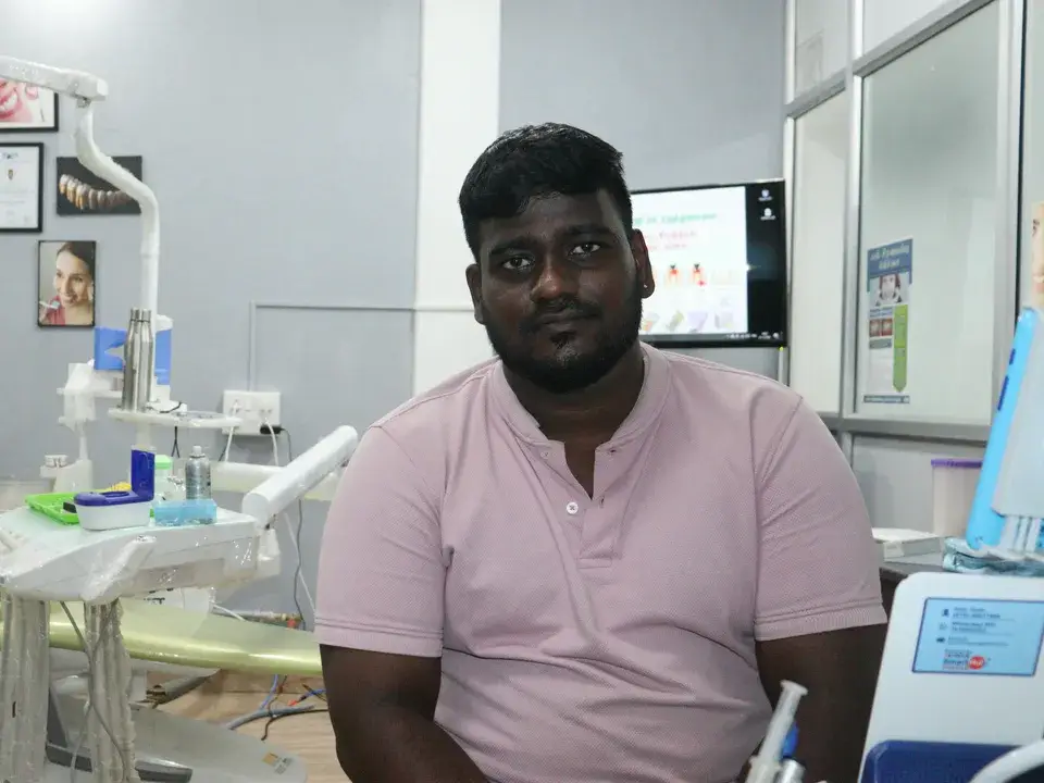 Anand, impacted tooth surgery patient, in the treatment room at M R Balaji Dental Clinic